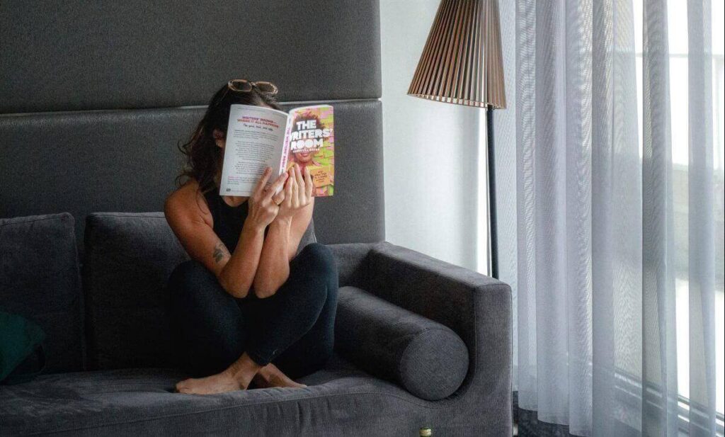 Woman sitting in on a sofa in a corporate stays apartments in Toronto